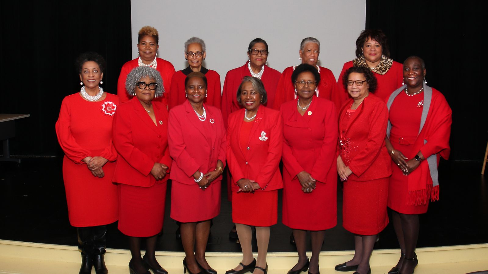 Past Presidents taken in 2025 - Women dressed in red standing in two rows